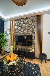 a living room with a fireplace with plates on the wall at Apartament Blue Diamond in Karpacz