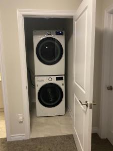 a washer and dryer in the corner of a room at Poise Homes Guest Home Cambridge in Cambridge