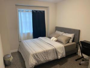 a bedroom with a large bed with a window at Poise Homes Guest Home Cambridge in Cambridge