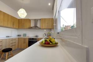 a kitchen with a bowl of fruit on a counter at Koroni House in Heraklio Town