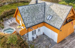an overhead view of a house with a roof at Lovely Home In Kvamsy With Jacuzzi in Sandvik