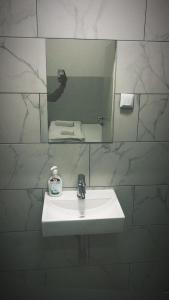 a bathroom with a white sink and a mirror at Aparthotel MERDIAN in Vienna