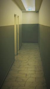 an empty room with a tile floor and a hallway at Aparthotel MERDIAN in Vienna