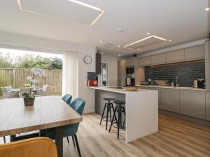 a kitchen and dining room with a table and chairs at Lilac Cottage in Lymington