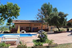 a villa with a swimming pool and a house at Rocaplana Club de Campo in Vilarrodona