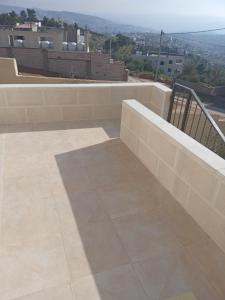 a balcony with a view of a city at شقة فندقيه مفروشه in Jerash