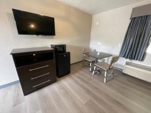 a small room with a table and a television at VILLA INN in Anaheim