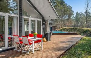 a patio with a table and chairs on a house at Stunning Home In Nykøbing Sj With Sauna in Nykøbing Sjælland +21 photos