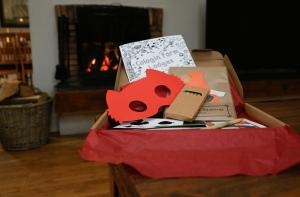 a box filled with items on a table with a fireplace at Cologin Farmhouse in Oban