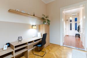 a home office with a desk and a chair at City Center Apartment Debrecen in Debrecen