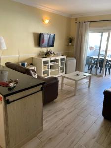 a living room with a couch and a table at Casa MaGia in Playa de las Americas