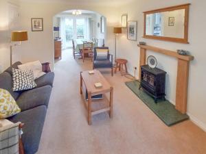 a living room with a couch and a fireplace at Homewood in Alnwick