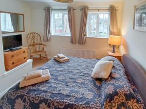 a bedroom with a bed with two pillows on it at Homewood in Alnwick