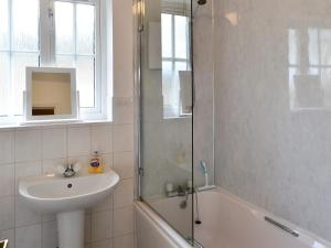 a bathroom with a sink and a glass shower at Homewood in Alnwick
