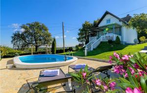 a house with a swimming pool in front of a house at Beautiful Home In Radovan With 2 Bedrooms, Wifi And Sauna in Gačice
