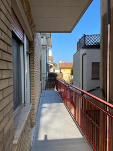 a balcony with a walkway next to a building at Viale Pascoli Due in Cesenatico