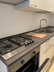 a kitchen with a stove and a sink at Viale Pascoli Due in Cesenatico