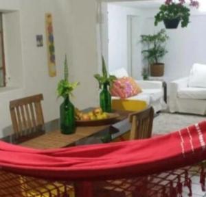 a living room with a table with a red cloth on it at Porão reformado no centro de Floripa in Florianópolis