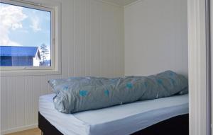 ein Bett mit blauer Decke neben einem Fenster in der Unterkunft Lovely Home In Moi With House Sea View in Moi