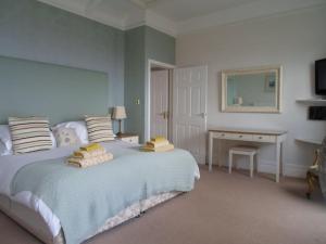 a bedroom with a bed with two pillows on it at Oyster Cottage in The Mumbles