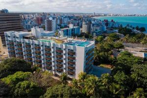 an aerial view of a large building with the ocean at Flat com vista perfeita e área completa de lazer! in João Pessoa