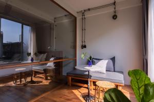 a room with a bed and a table and chairs at GalileOasis Boutique Hotel in Bangkok