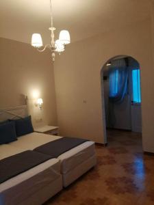 a bedroom with a large bed and a blue curtain at Dionisia Apartments 2 in Kefalos