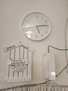 a clock hanging on a wall with signs on it at DREAM HOUSE in Naples +95 photos