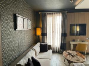 a living room with a white couch and a table at Hotel Zade in Erzurum