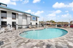 a swimming pool in front of a hotel at Regency Inn Near Boardwalk & Hurlburt Field in Fort Walton Beach