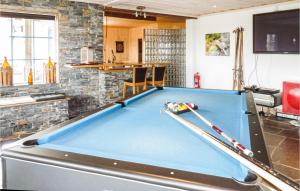 a pool table in a living room at Lovely Home In Trysil With House A Mountain View in Mælem