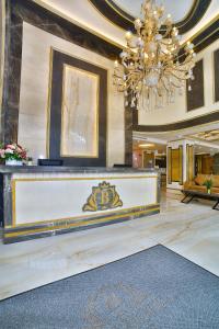 a large lobby with a chandelier and a reception desk at Büke Hotel in Istanbul