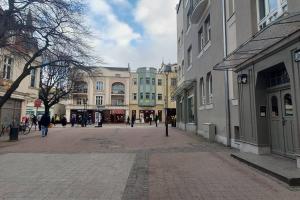 a city street with buildings and people walking around at Pod Mewą Sopot Monte Cassino NEW in Sopot