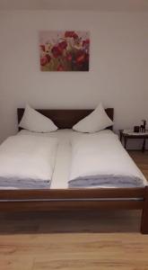 a bed with two pillows on it in a room at APARTMAN MILICA in Požarevac