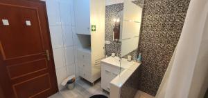 a bathroom with a sink and a mirror at Monte Gordo T2 Frente Mar in Monte Gordo +44 photos
