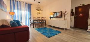 a living room with a couch and a dining room at Monte Gordo T2 Frente Mar in Monte Gordo