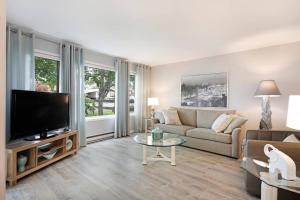 a living room with a couch and a tv at 14th Street Suites in Courtenay