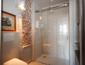 a bathroom with a shower with a glass door at Due Colonne - Menaggio by LoveComo in Menaggio +7 photos