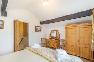 a bedroom with a bed and a dresser at Journeyman Loft in Skipton +10 photos