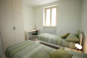 Postel nebo postele na pokoji v ubytování Casa Luisella - Sala Comacina by LoveComo