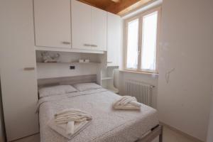 Postel nebo postele na pokoji v ubytování Casa Luisella - Sala Comacina by LoveComo