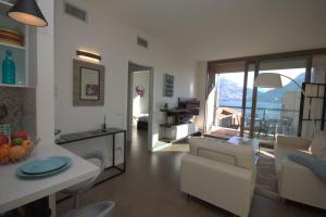 a living room with a dining table and a living room at Vista Panorama Jewel - Acquaseria, San Siro by LoveComo in San Siro