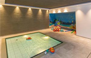an indoor swimming pool in a room with an aquarium at Nice Apartment In Klsterle With 1 Bedrooms, Outdoor Swimming Pool And Heated Swimming Pool in Klösterle