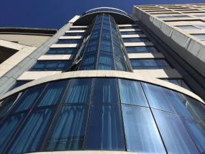 a tall building with blue glass windows at Crystal Palace Hotel in Montevideo