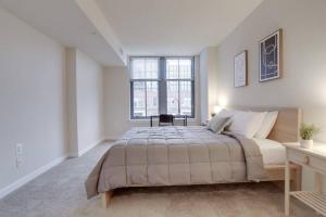 a bedroom with a large bed and a window at Spacious 2 BR Apartment At Pentagon City in Arlington