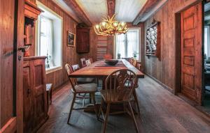 comedor con mesa de madera y sillas en Gorgeous Home In Nybergsund With Kitchen, en Nybergsund
