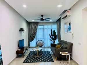 a living room with a couch and a table at Selayang 18 Residences (100mbps Wifi & Netflix) in Batu Caves