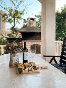 einen Tisch mit einer Flasche Wein und zwei Gläsern in der Unterkunft VILLA MARE in Supetar