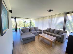 a living room with a couch and a coffee table at Dpto de Categoría en Arelauquen Golf & Country in San Carlos de Bariloche