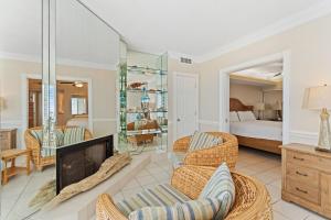 a living room with a fireplace and a bedroom at Summer House 1501B in Orange Beach +75 photos